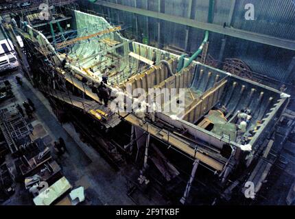 AJAXNETPHOTO. 9TH MARCH, 1971. WOOLSTON, ENGLAND. - WORLD'S LARGEST PLASTIC WARSHIP - HMS WILTON, A 'TON' CLASS MINESWEEPER FOR THE ROYAL NAVY UNDER CONSTRUCTION AT THE VOSPER THORNYCROFT SHIPYARD IN WOOLSTON. VOSPER GLASS FIBRE TECHNOLOGY LED THE WAY. THE LAST VESSEL TO BE BUILT AT THE WOOLSTON YARD WAS THE 75M MIRABELLA V, THE WORLD'S LARGEST GLASS FIBRE SINGLE MASTED YACHT.  PHOTO:JONATHAN EASTLAND/AJAX.  REF: CN357113 Stock Photo