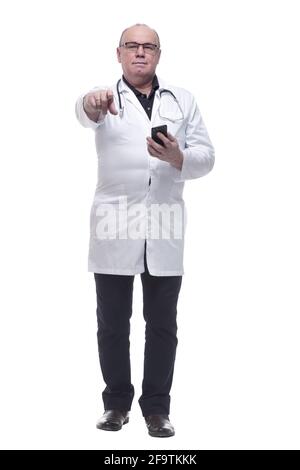 in full growth. Mature doctor reading a message on his smartphone Stock Photo