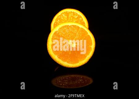 Two half oranges isolated on black Stock Photo