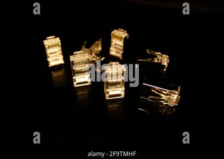 UTP and FTP cable adapters isolated on black with reflections Stock Photo