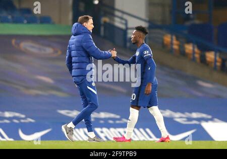 Chelsea manager Thomas Tuchel fist bumps Callum Hudson-Odoi (right) after the final whistle blows, after the Premier League match at Stamford Bridge, London. Picture date: Tuesday April 20, 2021. Stock Photo