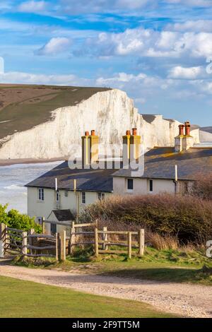 View of the Seven Sisters cliffs and the coastguard cottages, from Seaford Head across the River Cuckmere.  Seaford, Sussex, England, United Kingdom. Stock Photo