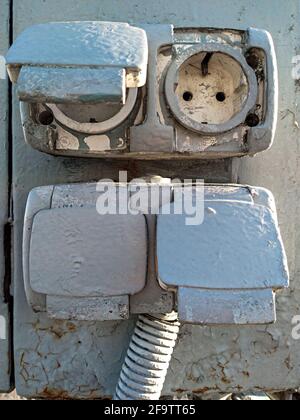 Old painted rustic european electrical outlet on a exterior wall Stock Photo