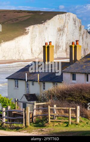 View of the Seven Sisters cliffs and the coastguard cottages, from Seaford Head across the River Cuckmere.  Seaford, Sussex, England, United Kingdom.