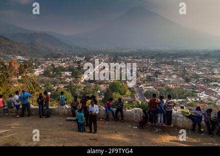 ANTIGUA, GUATEMALA - MARCH 27, 2016: People watch the city from the Cerro de la Cruz viewpoint in Antigua, Guatemala Stock Photo