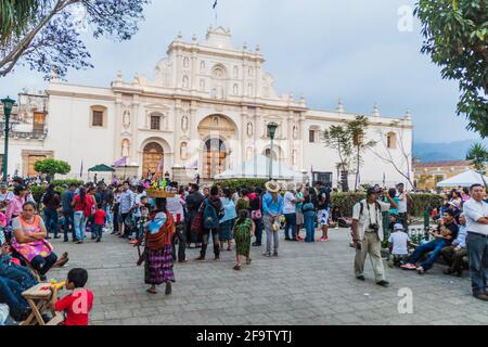 ANTIGUA, GUATEMALA - MARCH 25, 2016: Crowds of people in front of San Jose cathedral on Plaza Mayor square in Antigua Guatemala town, Guatemala. Stock Photo