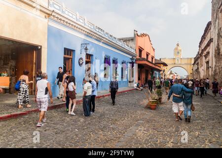 ANTIGUA, GUATEMALA - MARCH 26, 2016: Crowds of people on the street in Antigua Guatemala town, Guatemala. Santa Catalina Arch visible. Stock Photo
