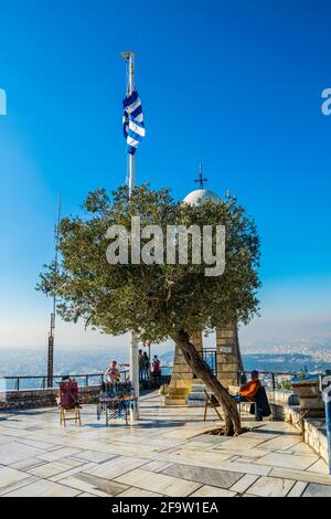 ATHENS, GREECE, DECEMBER 10, 2015: a group of tourists is admiring view of athens from the top of lycabetus hill Stock Photo