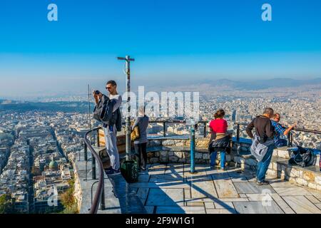 ATHENS, GREECE, DECEMBER 10, 2015: a group of tourists is admiring view of athens from the top of lycabetus hill Stock Photo