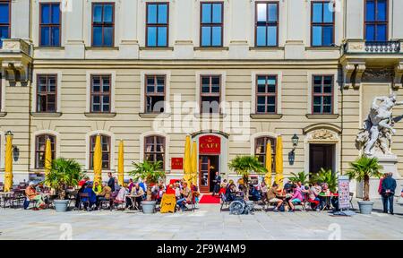 VIENNA, AUSTRIA, JUNE 6, 2015: tourists are sitting in a cafe situated on the main courtyard of hofburg palace in vienna Stock Photo