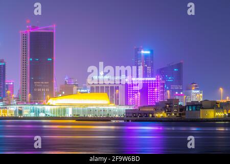 MANAMA, BAHRAIN, OCTOBER 22, 2016: Skyline of Manama with the Bahrain National theater during sunset, Bahrain. Stock Photo