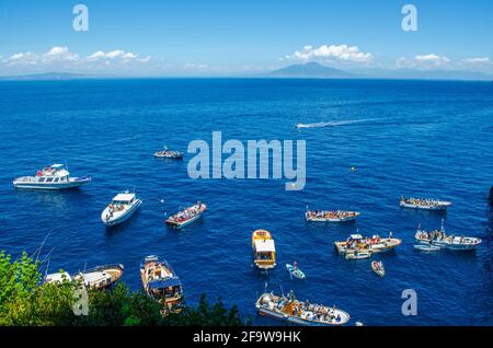 CAPRI, ITALY, MAY 15, 2014: peoplea re waiting on various boats in order to get into the famous grotta azzura situated on capri island in the bay of n Stock Photo