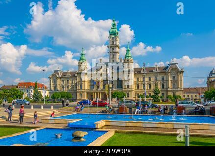 GYOR, HUNGARY MAY 20, 2016: People are sitting around a singing fountain situated in front of the town hall in the hungarian city Gyor. Stock Photo