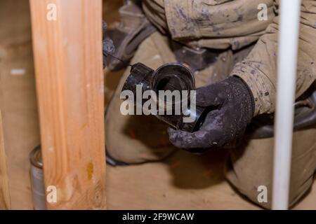 Plumbing contractor installing PVC plastic drain pipe in the section for custom house Stock Photo