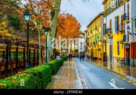 GRANADA, SPAIN, JANUARY 3, 2016: View of a street with bars and restaurants situated on riverside of river darro in spanish city granada Stock Photo