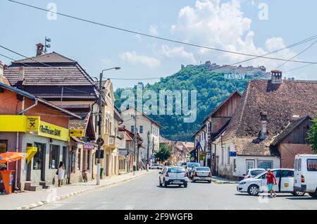 RASNOV, ROMANIA, JULY 8, 2015: Medieval fortress on the hill, sign with the town name and church in Rasnov, Transylvania, Romania Stock Photo