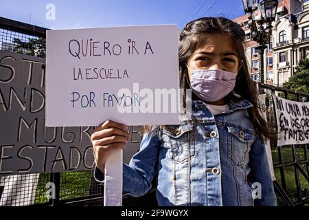 Buenos Aires, Federal Capital, Argentina. 20th Apr, 2021. In the photograph a girl holds a banner that reads ''Quiero ir a la Escuela Por Favor'' (I want to go to school please) during a protest in the vicinity of the Supreme Court of Justice of the Argentine Nation in demand for face-to-face classes in schools.The Federal Justice ordered the Government of the City of Buenos Aires to suspend on-site classes until the Supreme Court of Justice decides on the matter, a measure that leaves without effect the injunction filed by parents of students against the Necessity and Urgency Decree, signed Stock Photo