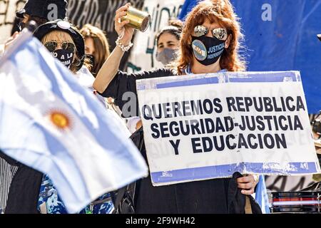 Buenos Aires, Federal Capital, Argentina. 20th Apr, 2021. In the photograph, demonstrators with mouthpieces, slogans and Argentinean flags, protest at the door of the Supreme Court of Justice of Argentina to demand the continuity of classroom classes in the City of Buenos Aires, in the middle of the second wave of the pandemic. One of them holds a banner that reads: ''We want Republic, Security, Justice and Education''.The Federal Justice ordered the Government of the City of Buenos Aires to suspend on-site classes until the Supreme Court of Justice decides on the matter, a measure that leave Stock Photo