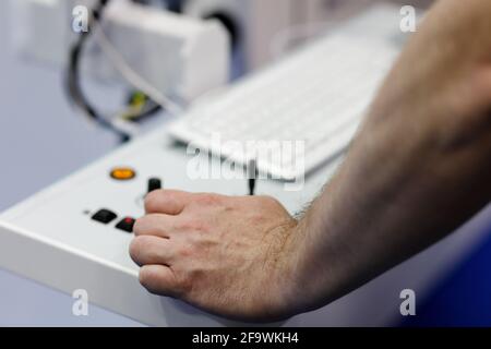 Machine tool operator working with computer-operated equipment. Selective focus. Stock Photo