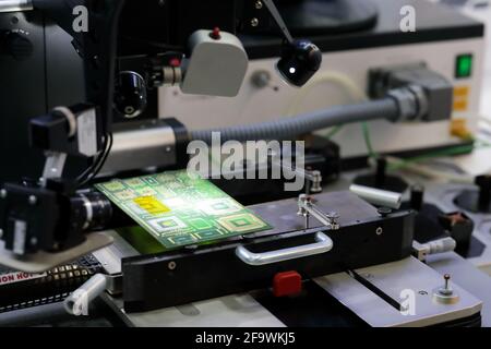 Professional printed circuit boards repair machine. Selective focus. Stock Photo