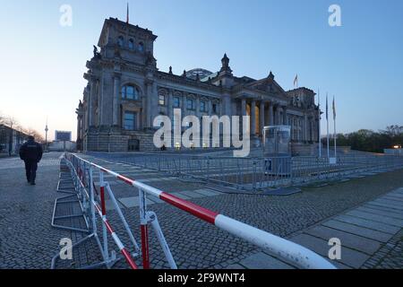 Berlin, Germany. 21st Apr, 2021. A double fence is erected in front of the Reichstag building. A demonstration against the Corona restrictions has been announced for today. Credit: Jörg Carstensen/dpa/Alamy Live News Stock Photo