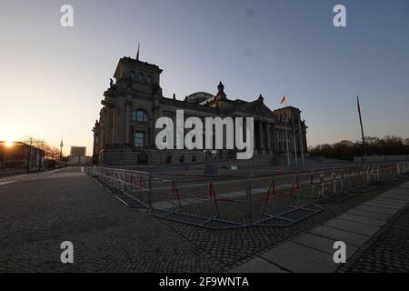 Berlin, Germany. 21st Apr, 2021. A double fence is erected in front of the Reichstag building. A demonstration against the Corona restrictions has been announced for today. Credit: Jörg Carstensen/dpa/Alamy Live News Stock Photo