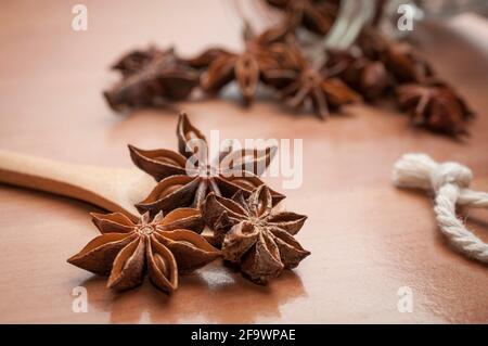 Some star anise seeds and fruits on wooden spoon Stock Photo