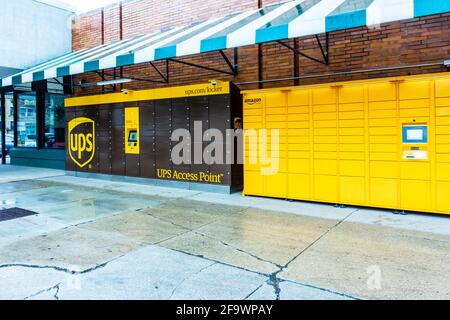 A curbside UPS Access Point and Amazon parcel locker next to each other in Chicago, Illinois for secure contactless delivery of packages. Stock Photo