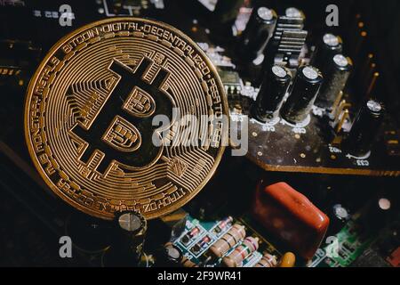 Bitcoin in. Solid shape resting in electronic computer circuits Stock Photo