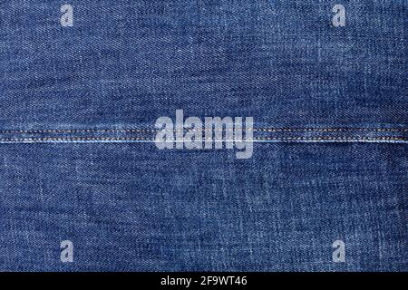 Blue jeans texture and seam closeup, thread stitch line, jean textile background, dark blue denim backdrop, jeans pattern, indigo jeans cloth, grunge Stock Photo