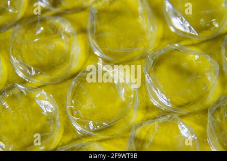 Part of the packaging bubble wrap on a yellow background. Close-up Stock Photo