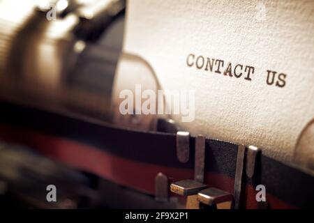 Contact us phrase written with a typewriter. Stock Photo