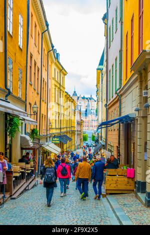 STOCKHOLM, SWEDEN, AUGUST 19, 2016: People are strolling on a street in the Gamla Stan district in central Stockholm, Sweden. Stock Photo