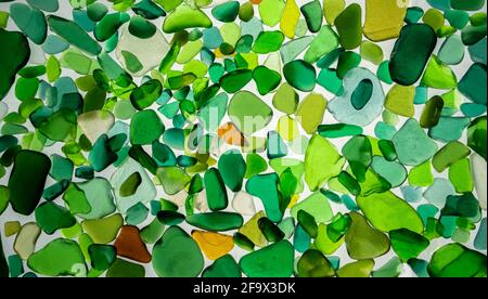 Summer background from sea glass top view. Broken glass from the ocean. Sea pattern. Oceanic mosaic. Natural colors of blue, green, white found on the Stock Photo