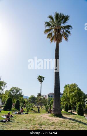 BARCELONA, SPAIN - JUNE 08, 2019: People Having Picnic And Relaxing On Summer Day In Parc de la Ciutadella Or Citadel Park In Barcelona Stock Photo