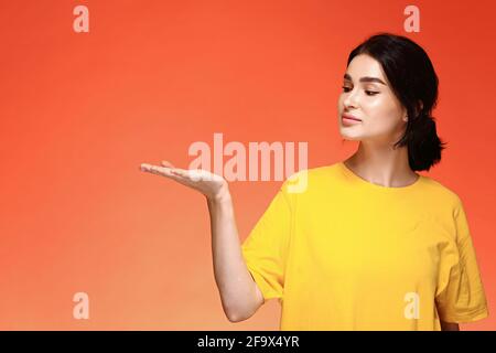 Portrait of young woman looking at her hand mock up Stock Photo