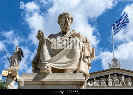 The statues of Plato and goddess Athena the defender on the background, outside the Academy of Athens. Stock Photo