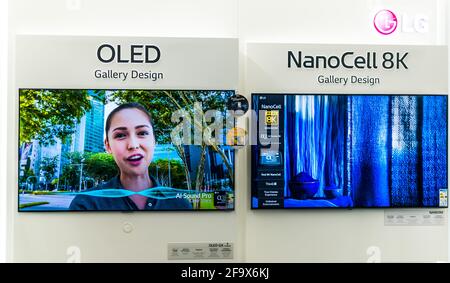 POZNAN, POL - FEB 24, 2021: Modern flat-screen TV sets by LG put up for sale in an electronics store Stock Photo