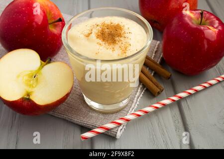 Smoothies from red apples and cinnamon on the grey napkin Stock Photo