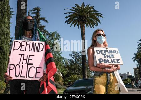 Los Angeles, United States. 20th Apr, 2021. Protesters hold placards during the demonstration. Hours after the verdict of the Derek Chauvin trial, protesters meet outside of Los Angeles Mayor Eric Garcetti's home to protest his proposed funding of the Los Angeles Police Department. Credit: SOPA Images Limited/Alamy Live News Stock Photo