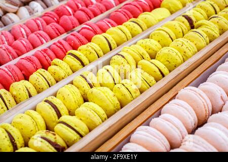 Colorful french macarons in wooden trays, close up. Different colorful macaroons background.Tasty sweet color macaron, Bakery concept. Selective focus Stock Photo