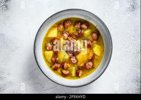 German Split pea soup with smoked sausages. White background. Top view Stock Photo