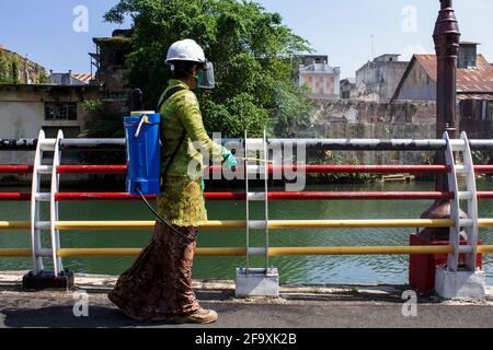 Padang, Indonesia, 21st April 2021. Women in Indonesia, Padang City, West Sumatra province wear the Kebaya to celebrate Kartini Day and spraying disinfectants on public roads in Batang Arau Village. Kariadil Harefa. Stock Photo