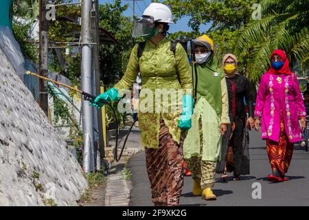 Padang, Indonesia, 21st April 2021. Women in Indonesia, Padang City, West Sumatra province wear the Kebaya to celebrate Kartini Day and spraying disinfectants on public roads in Batang Arau Village. Kariadil Harefa. Stock Photo