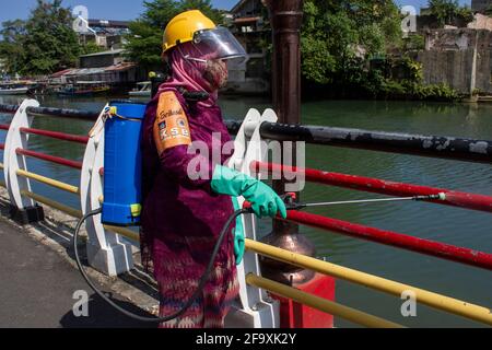 Padang, Indonesia, 21st April 2021. Women in Indonesia, Padang City, West Sumatra province wear the Kebaya to celebrate Kartini Day and spraying disinfectants on public roads in Batang Arau Village. Kariadil Harefa. Stock Photo