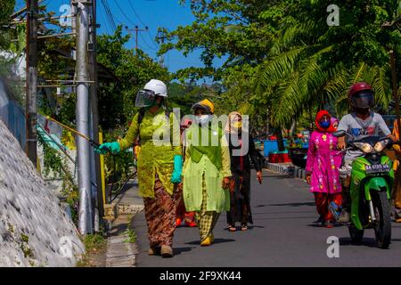 Padang, Indonesia, 21st April 2021. Women in Indonesia, Padang City, West Sumatra province wear the Kebaya to celebrate Kartini Day and spraying disinfectants on public roads in Batang Arau Village. Kariadil Harefa. Stock Photo