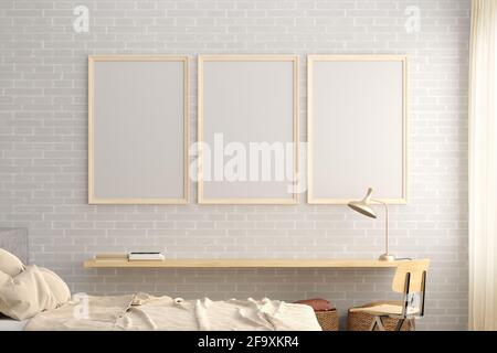 Three vertical blank poster frames mock up on the white brick wall in interior of loft bedroom Stock Photo