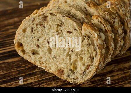 Gluten-free vegan bread and no animal products. Vegetarian bread with oatmeal, banana flavor, on a wooden rustic table, sliced and ready to serve Stock Photo