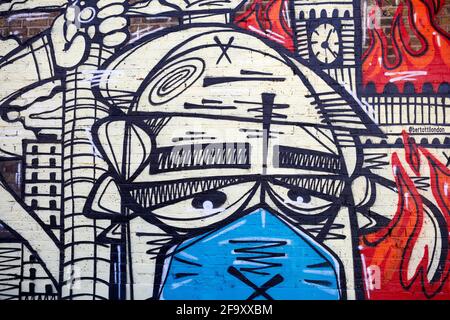 London, UK - 18 Apr 2021: A street mural, drawn during the coronavirus pandemic by graffiti artist Panik, on the side wall of an ice-cram shop . Stock Photo