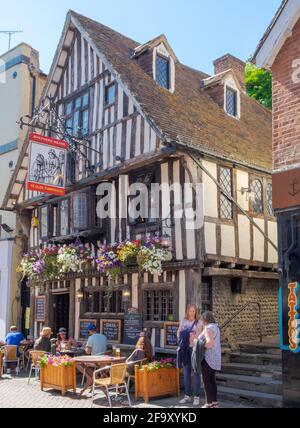 Staycation idea. People drink & eat at outside tables at Ye Olde Pumphouse pub & restaurant, George Street, Old Town Hastings, on a sunny summer day. Stock Photo